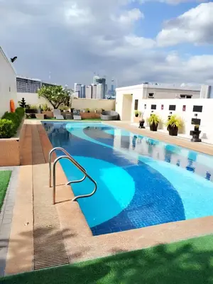 a large swimming pool on top of a building at Affordable Condo Suite with WIFI in McKinley BGC in Manila