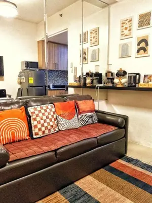 a couch with pillows on it in a living room at DS Staycation in Manila