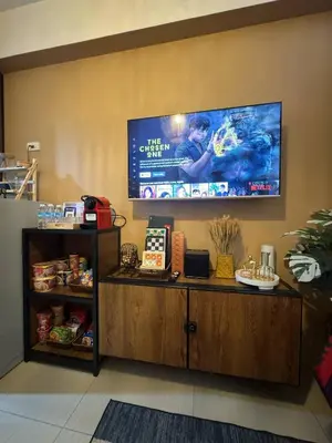 a tv on the wall of a store at Balay Maria at Shore in Manila