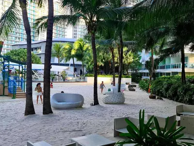 a beach with palm trees and a volley ball court at 1BR Unit Azure Urban Resort Residences in Manila
