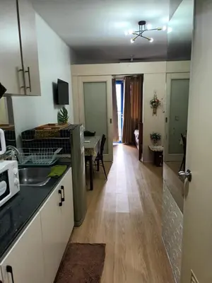 a kitchen with a counter and a dining room at Sea Residences Yanah Staycation in Manila