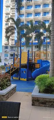 a playground in front of a large apartment building at Sea Residences Yanah Staycation in Manila