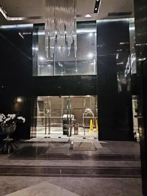 a lobby with a chandelier in a building at Milano residences in Manila