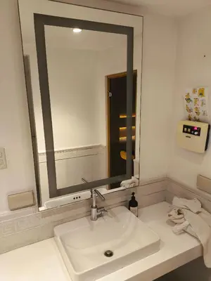a bathroom with a sink and a large mirror at Milano residences in Manila
