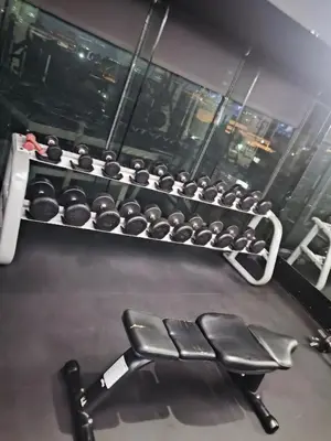 a gym with a rack of dumbbells at Milano residences in Manila
