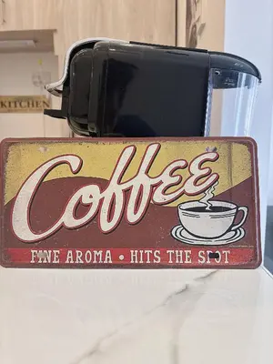 an old coca cola sign with a cup of coffee at Cozy Loft Condo in Tanza with Arcade in Tanza