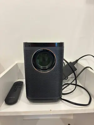 a camera sitting on a shelf with a remote control at Cozy Loft Condo in Tanza with Arcade in Tanza