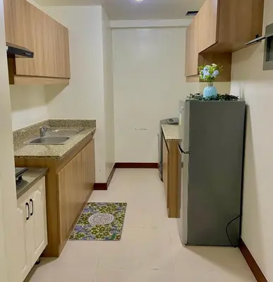 a kitchen with a refrigerator and a sink at V-TAN condo in Manila