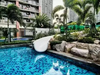 a swimming pool with a slide in a resort at V-TAN condo in Manila