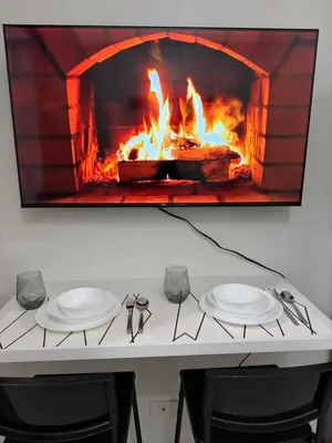 a table with two plates and a fire oven at Metro Prime Stays at Shore 2 Residences in Manila