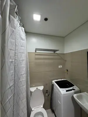 a small bathroom with a toilet and a sink at Metro Prime Stays at Shore 2 Residences in Manila