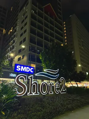 a sign for a store in front of a building at Philhaus Staycation in Manila