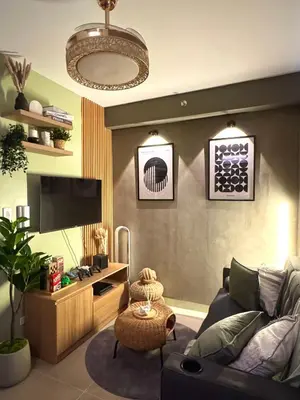 a living room with a couch and a tv at Philhaus Staycation in Manila