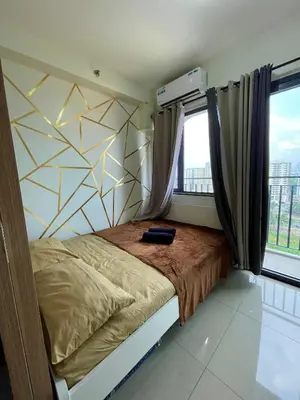 a bedroom with a bed and a large window at Teychi's Staycation at Shore2 MOA Pasay in Manila