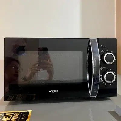 a person taking a picture of a microwave at Teychi's Staycation at Shore2 MOA Pasay in Manila