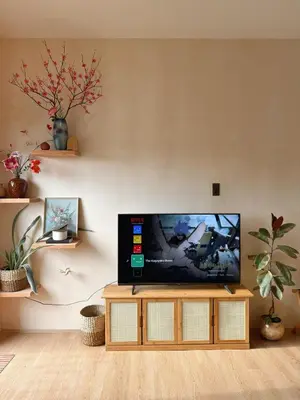 a living room with a flat screen tv on a table at Zen Staycation with City and Sunset View near Airport and Mckinley in Manila