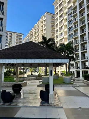 a pavilion in a park with buildings in the background at Solemare parksuites in Manila