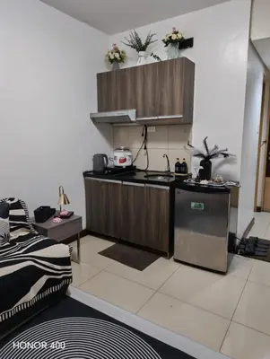 a kitchen with a sink and a stove at Solemare parksuites in Manila