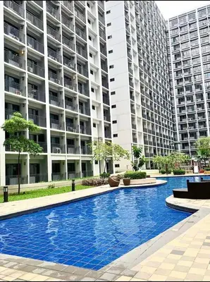 a swimming pool in front of a large apartment building at Shore 2 Tower 1 in Manila