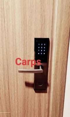 a lock on a door with a carps sign on it at Carps Staycation in Manila