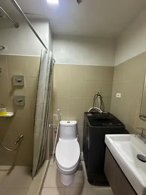 a bathroom with a toilet and a sink at Mall of Asia shore 3 Tower 21661 Residence in Manila