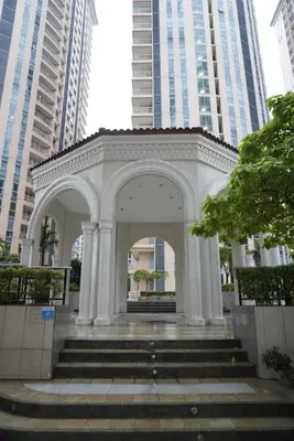 a white arch with stairs in front of tall buildings at Modern Rustic Pet Friendly Condo in Mckinley Hill BGC in Manila