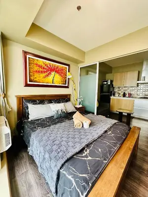 a bedroom with a large bed in a room at Condo near airport with PS4 and Parking in Manila