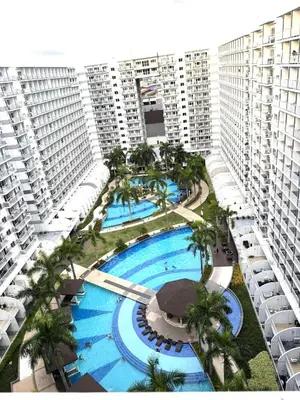 an overhead view of a pool in a building with palm trees at Bai Labi Luxury Lounge in Manila