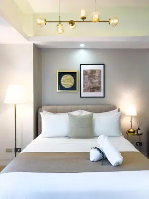 a bedroom with a large white bed with two pillows at Casa Elisae l Venice Grand Canal Mall Access in Manila