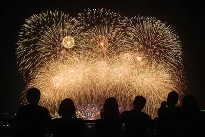 a group of people watching a firework display at night at 349B by Premiere Haven Shell Residences in Manila