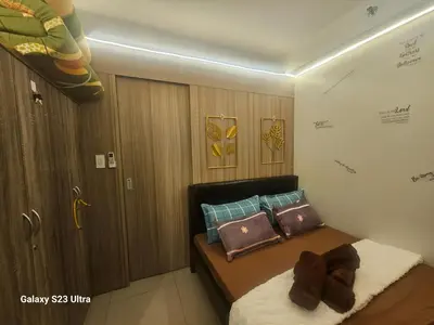 a small bedroom with a bed with pillows on it at Staycation near MOA, SMX Convention, DFA & NAIA, in Manila