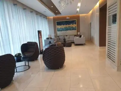 a large lobby with chairs and a living room at Shore 3 Residences Condo with Netflix and Wifi in Manila