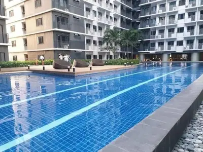 a large swimming pool in front of some apartment buildings at Shore 3 Residences Condo with Netflix and Wifi in Manila