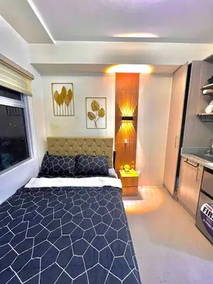 a bedroom with a large bed in a room at Mars Condo Unit in Manila