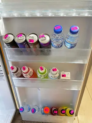 a refrigerator filled with lots of drinks and water bottles at Two Palm Tree Villas Across NAIA Terminal 3 in Manila