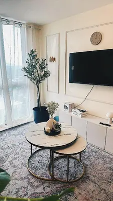 a living room with a table and a tv at Apartment in Pasig-khairo Residences in Manila
