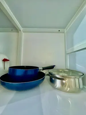 two blue pans sitting on top of a counter at Sea Residences Condominium in Manila