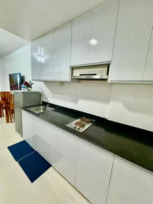 a kitchen with white cabinets and a counter top at Sea Residences Condominium in Manila