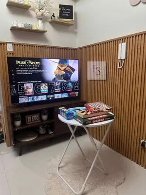 a table in front of a tv in a room at EyaLove's Staycation in Manila