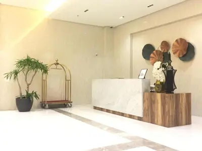 a reception desk in a lobby with flowers on it at RER-101 Newport Boulevard, Pasay City, Metro Manila, Philippines near NAIA Terminal 3 in Manila