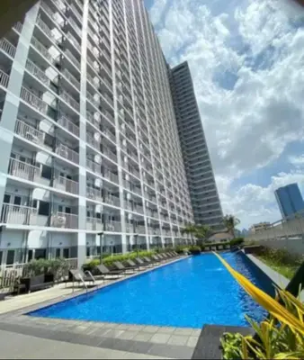 a large apartment building with a large swimming pool at SMDC Coast Residence in Manila