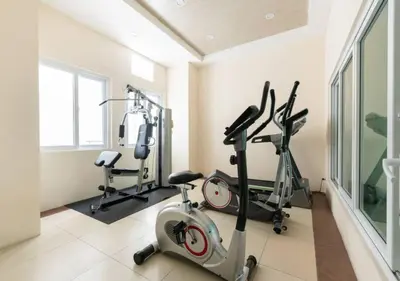 a gym with three exercise bikes in a room at Close by landmarks and airport in Manila