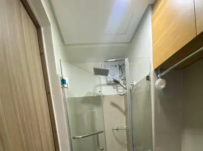 a shower with a glass door in a bathroom at The Nuebe Chalet near SM Moa Pasay City in Manila