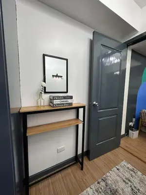 a room with a table and a blue door at 2BR Unit Azure Urban Resort Residences in Manila