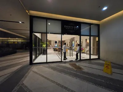a man and a woman standing outside of a store window at ScandiCozy Studio NAIA T3 Newport Wifi Pool Netflx in Manila
