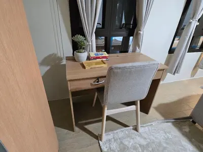 a wooden desk with a chair in a room at ScandiCozy Studio NAIA T3 Newport Wifi Pool Netflx in Manila
