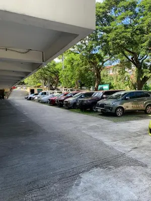 a row of cars parked in a parking lot at M&L Condotel in Santo Domingo