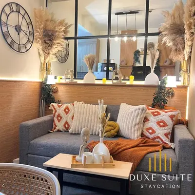 a living room with a couch and a table at Aesthetic walking distance to MOA,near NAIA AIRPORT with NETFLIX,MINIVIDEOKE,BOARDGAMES-DUXE9 in Manila