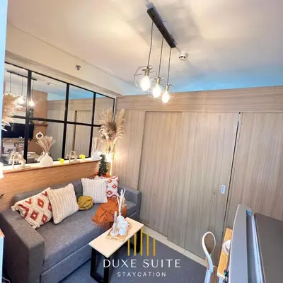 a living room with a couch and a table at Aesthetic walking distance to MOA,near NAIA AIRPORT with NETFLIX,MINIVIDEOKE,BOARDGAMES-DUXE9 in Manila