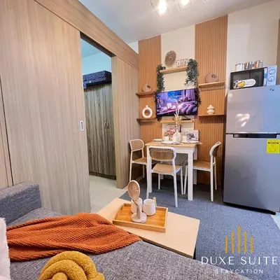 a living room with a table and a refrigerator at Aesthetic walking distance to MOA,near NAIA AIRPORT with NETFLIX,MINIVIDEOKE,BOARDGAMES-DUXE9 in Manila